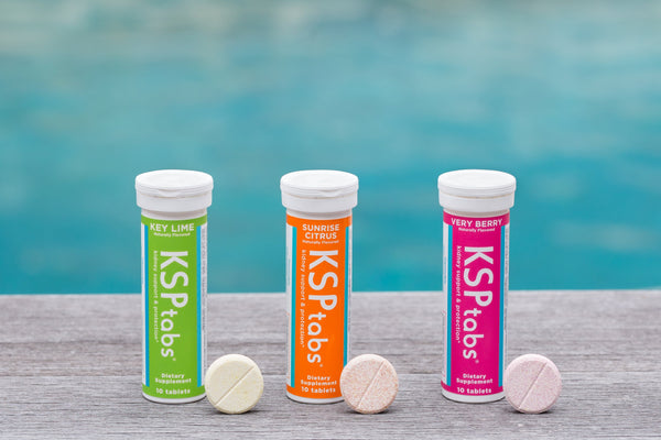 Three KSPtabs effervescent tablet tubes beside a pool